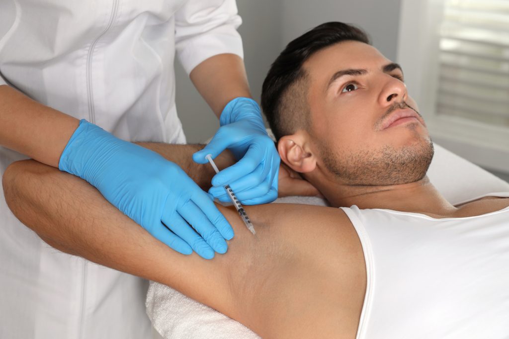 Botox injections manage hyperhidrosis by blocking impulses that trigger sweat glands.